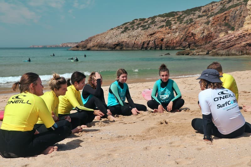 A surfer riding a wave during a lesson